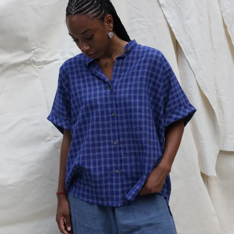 woman wearing a boxy blue checked shirt
