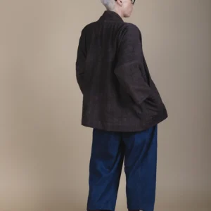 back view of woman wearing a brown jacket