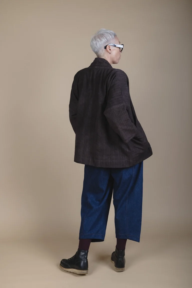 back view of woman wearing a brown jacket