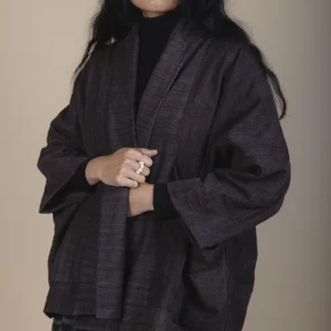 woman with long black hair wearing brown jacket