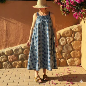 Full-length view of the Sunray organic cotton block printed dress in blue and white, featuring a relaxed one-size silhouette and adjustable drawstring straps.