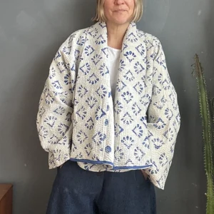 woman wearing a blue an white kantha jacket