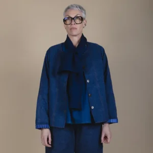 woman with grey hair wearing a patchwork denim jacket