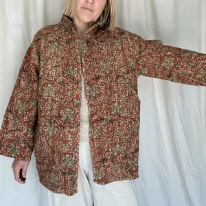 woman wearing a rusty brown floral kantha jacket
