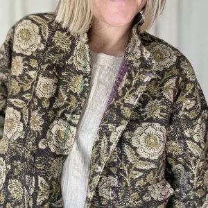 zoom in of woman wearing black floral kantha jacket