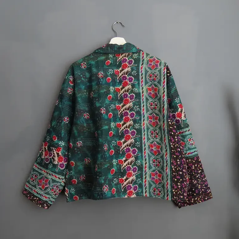 back side of kantha jacket hanging on a wall