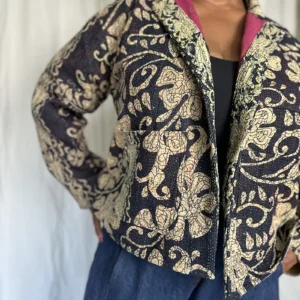 woman wearing a large floral kantha jacket