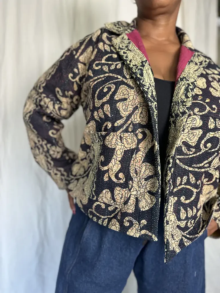 woman wearing a large floral kantha jacket