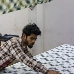 Master printer in Jaipur applying the Sunray block print to Indigowares organic cotton.