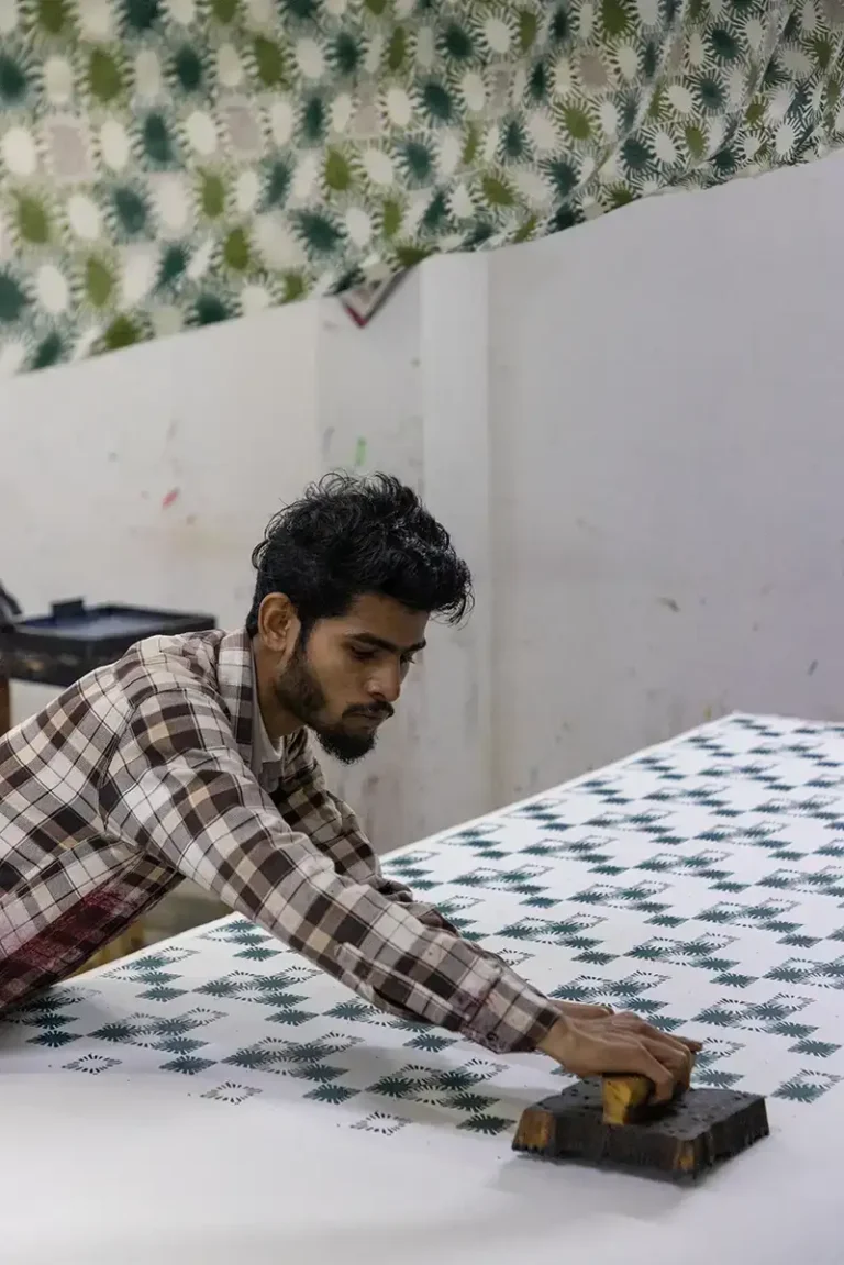 Master printer in Jaipur applying the Sunray block print to Indigowares organic cotton.