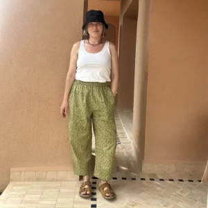 Woman wearing hand block printed camo trousers with a relaxed barrel leg fit.
