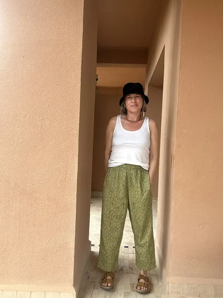 Woman wearing hand block printed camo trousers with a relaxed barrel leg fit.