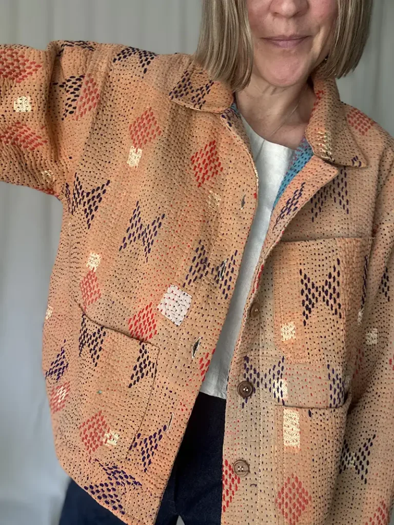 woman wearing a peach coloured kantha chore jacket