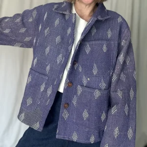woman wearing a faded purple kantha stitched chore jacket