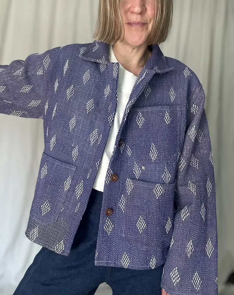 woman wearing a faded purple kantha stitched chore jacket