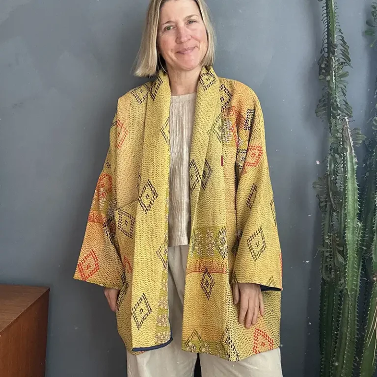 woman wearing yellow kantha stitched jacket