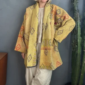 woman wearing yellow kantha jacket with black details