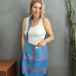 woman wearing a bright blue kantha stitched boho sling bag
