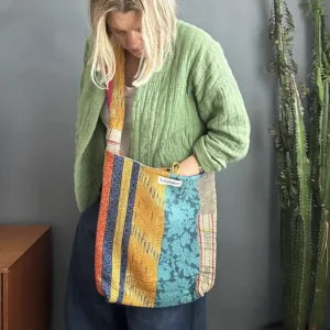 woman wearing a patchwork kantha fabric sling bag