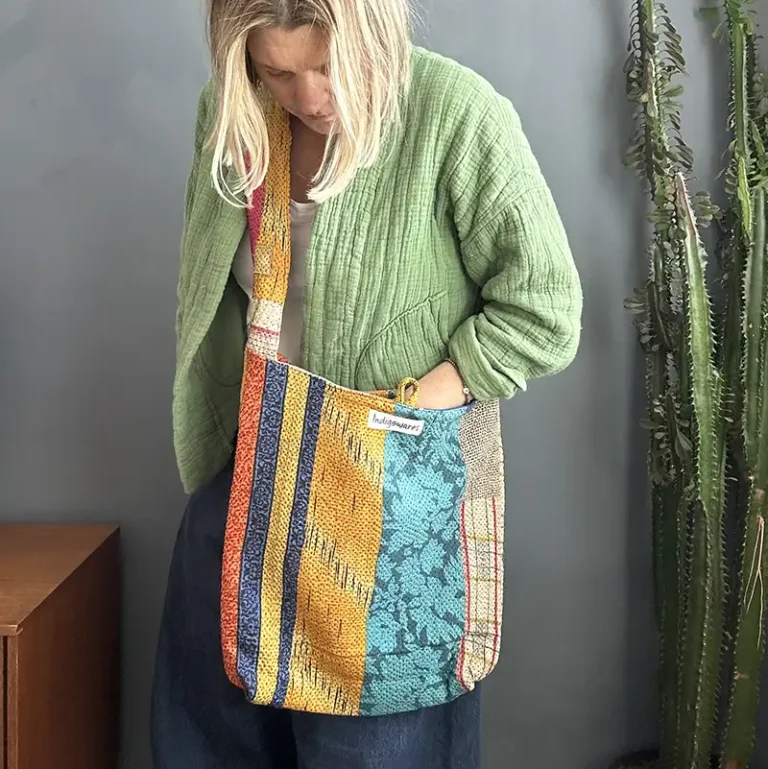 woman wearing a patchwork kantha fabric sling bag