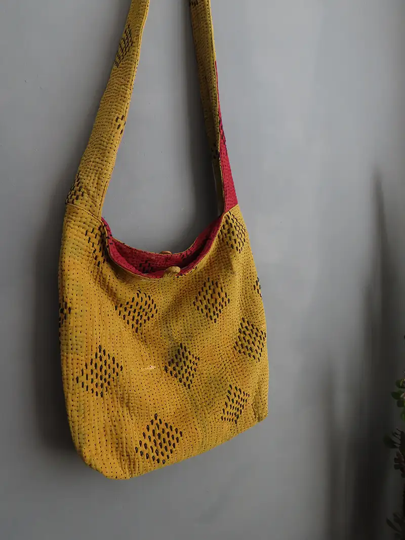zoom in of golden yellow kantha embroidery sling bag