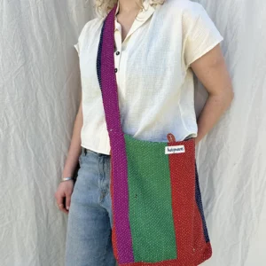 woman wearing green,red,purple and pink crossbody kantha embroidery fabric bag