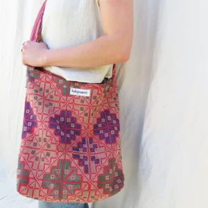 woman wearing a cross body kantha fabric bag