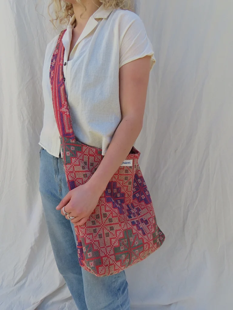 woman wearing kantha embroidery fabric sling bag