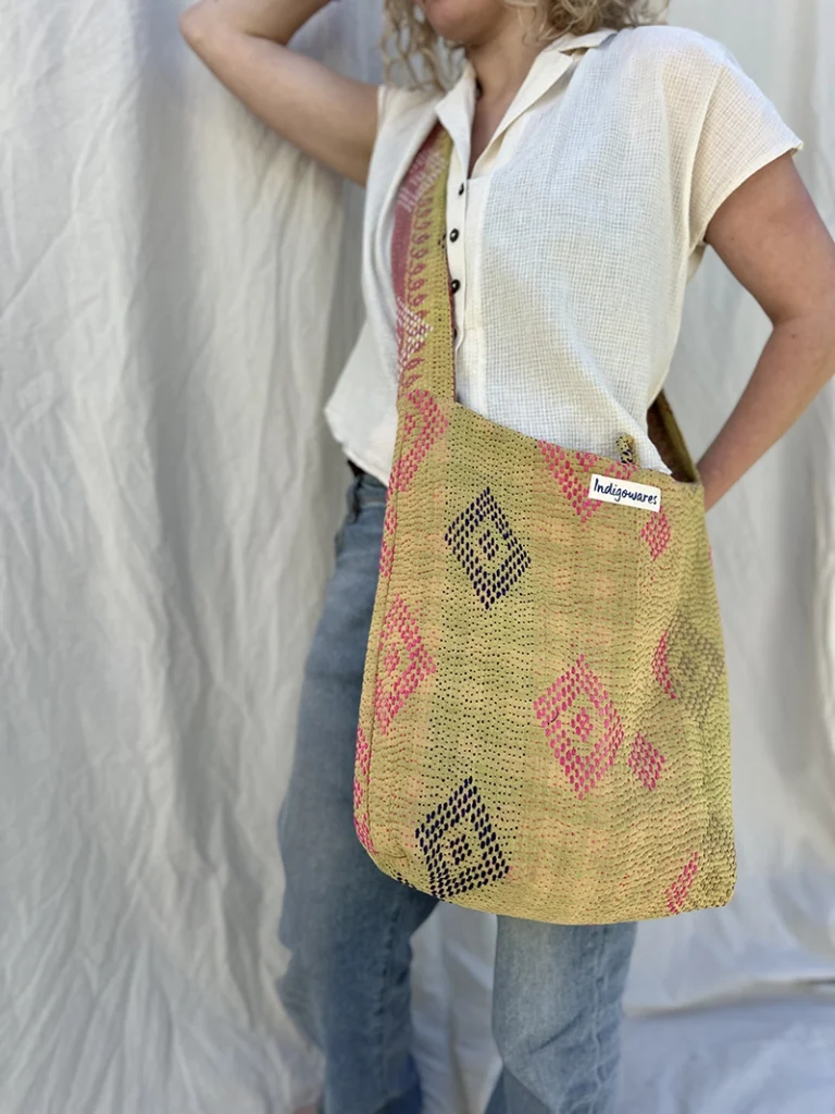woman wearing yellow kantha stitched sling bag