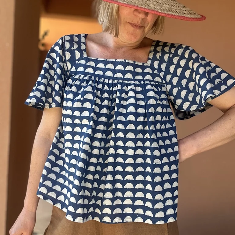 Woman wearing a blue and white Organic Cotton Block Print Top with geometric pattern.