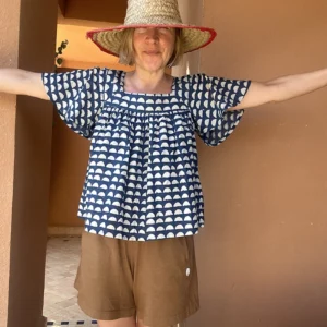 Woman wearing a blue and white Organic Cotton Block Print Top with geometric pattern.