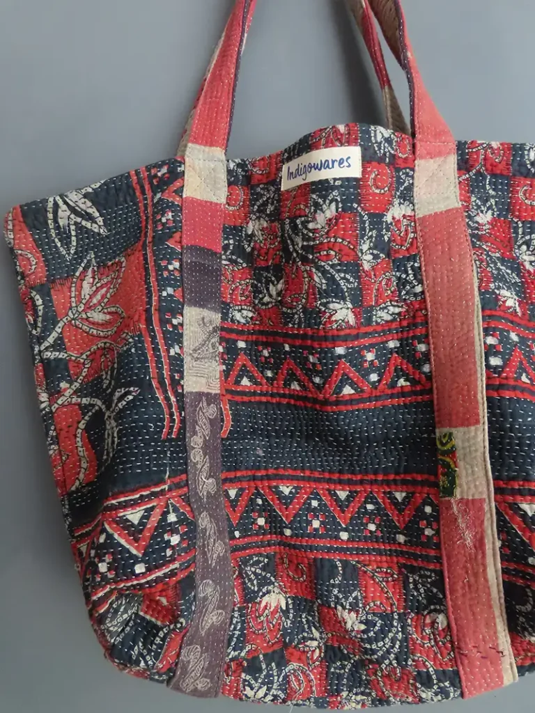 close up details of red and black patterned kantha fabric tote bag