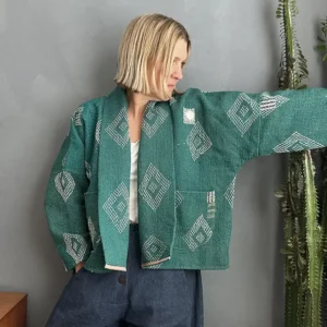 woman wearing green short kantha fabric jacket