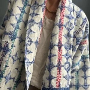 woman wearing a blue and white short kantha jacket