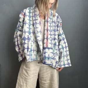 woman wearing a blue and white short kantha jacket