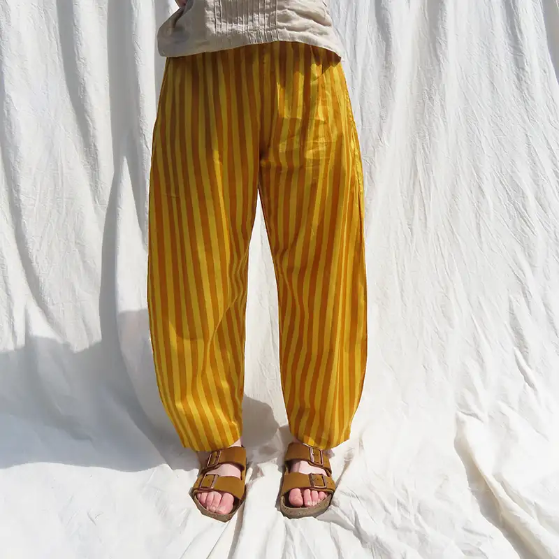 woman wearing yellow striped trousers