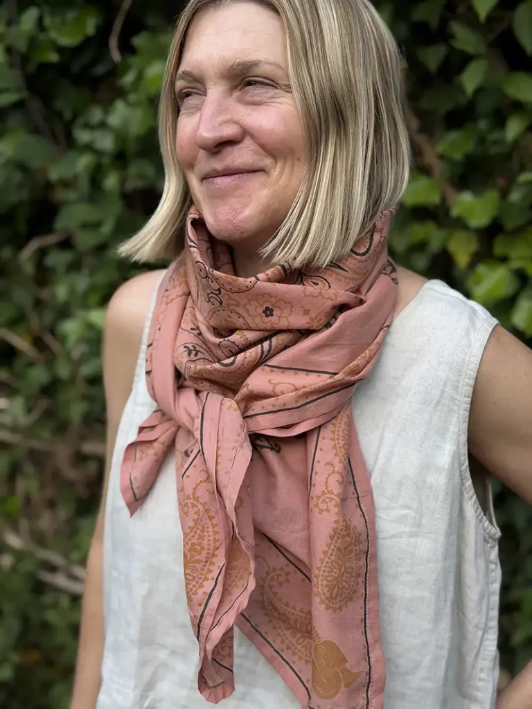 woman wearing large pink cotton scarf