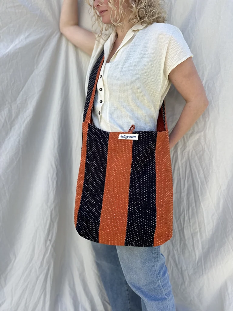 woman wearing striped fabric cross body bag