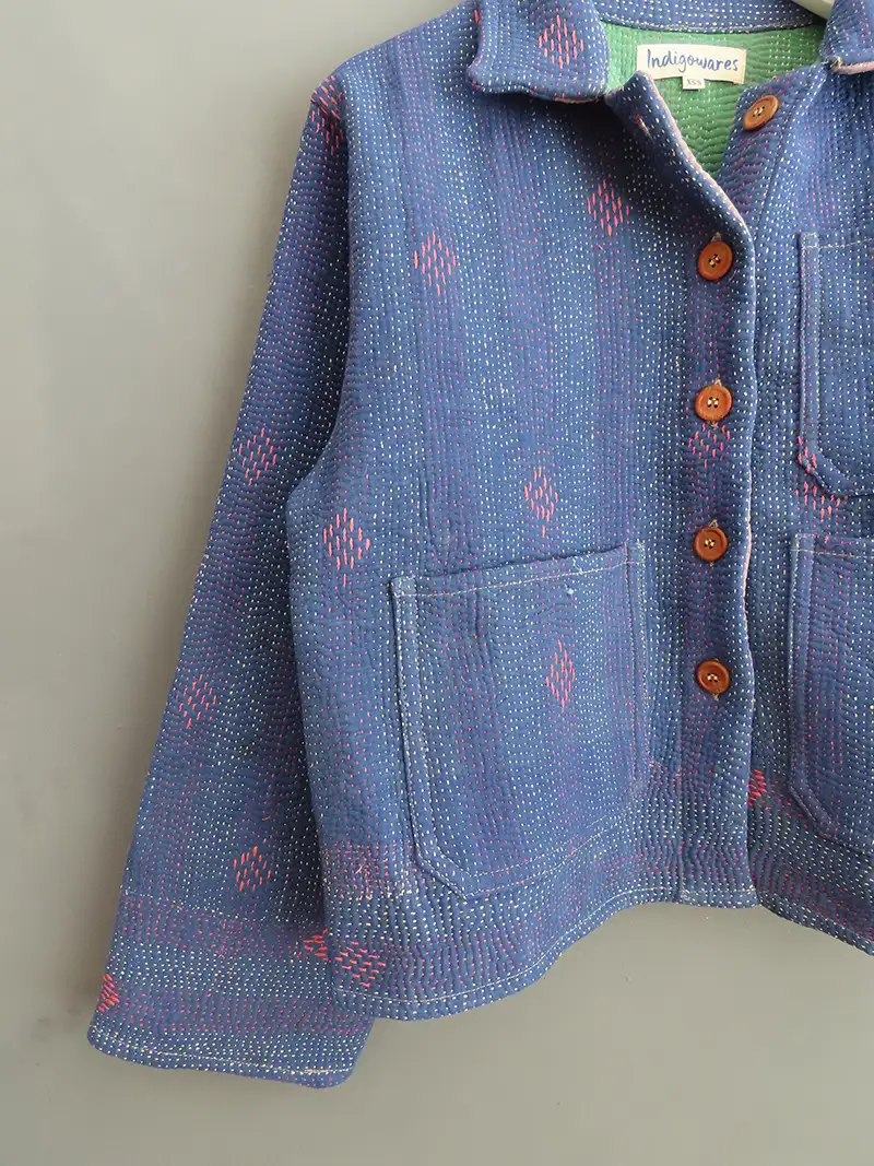 zoom in of kantha stitching on a blue jacket