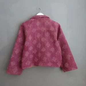 reverse side of kantha jacket hanging on a wall