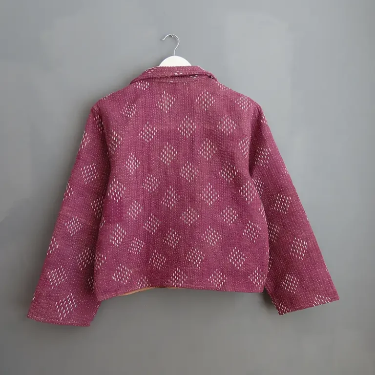 reverse side of kantha jacket hanging on a wall