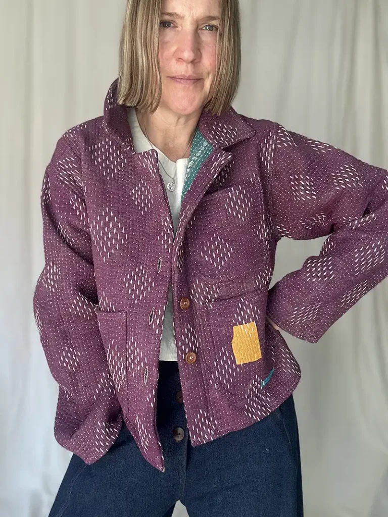 woman wearing a short purple kantha chore jacket