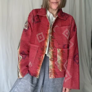 woman wearing bright red kantha chore jacket