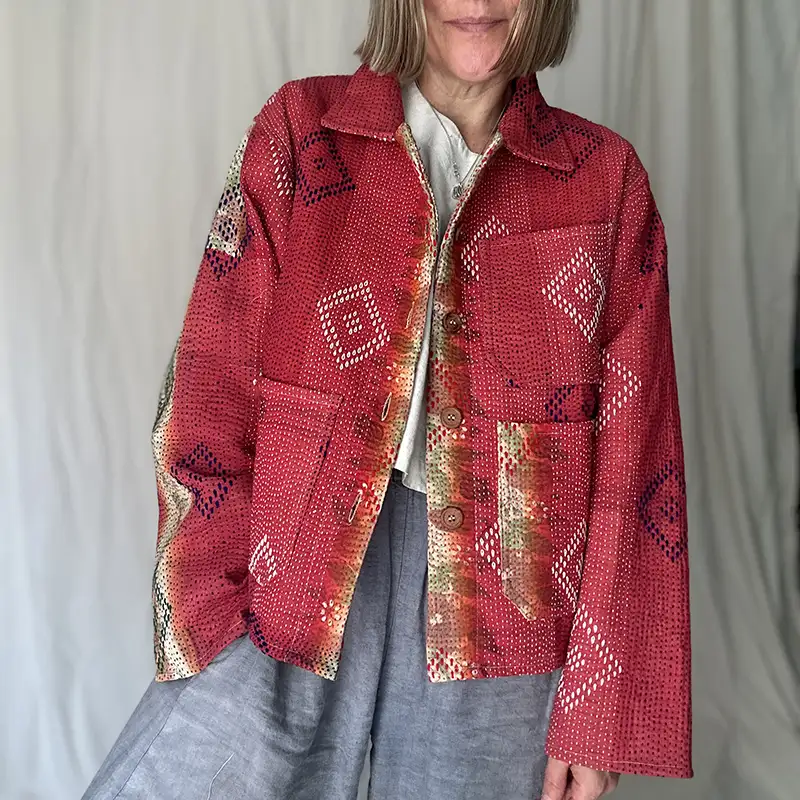 woman wearing bright red kantha chore jacket