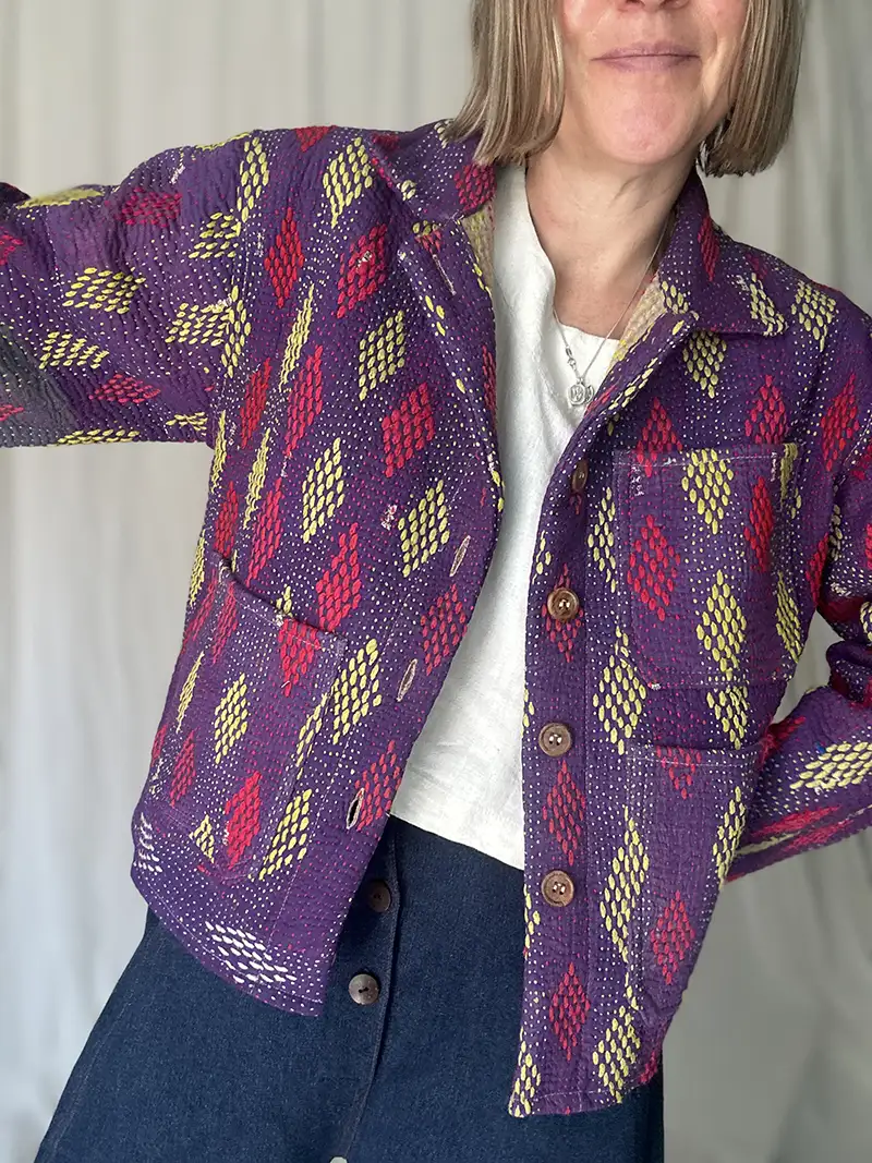zoom in woman wearing purple pattern kantha chore jacket