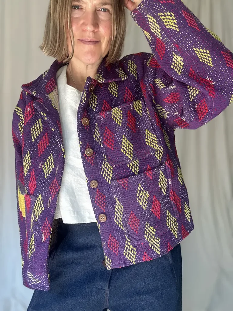 zoom in woman wearing purple pattern kantha chore jacket