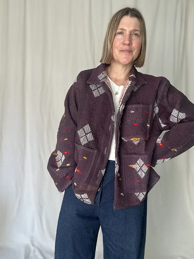 woman wearing a deep purple kantha embroidery jacket