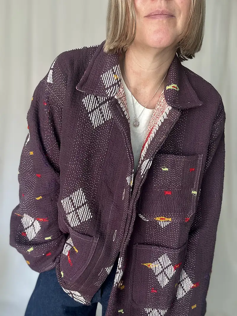 zoom in of woman wearing a kantha embroidery jacket