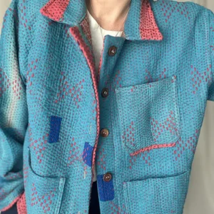 zoom in of woman wearing sky blue kantha chore jacket
