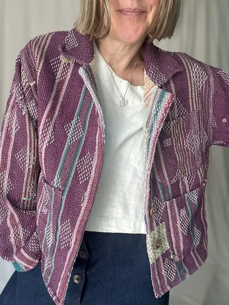 woman wearing a purple kantha jacket with buttons